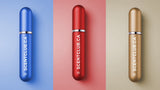 Three perfume atomizers in blue, red, and gold, each with the text scentclub.ca.