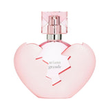 Ariana Grande Thank U, Next perfume bottle in a pink broken heart shape.