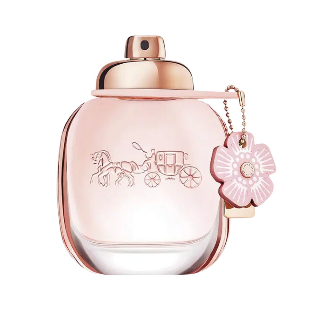 A pink Coach perfume bottle with a horse and carriage emblem and a flower charm.