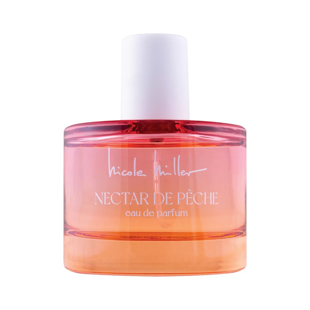 Bouteille de parfum Nectar de Pêche de Nicole Miller avec un liquide rose et orange.